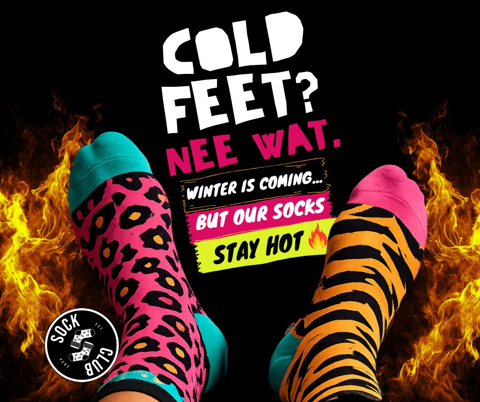 Person showing off bold, mismatched funky socks